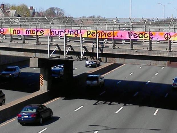 Dorchester art group DOT Art banner on highway 93 overpass heading into Boston (image via Boston.com by Peter McNamara)